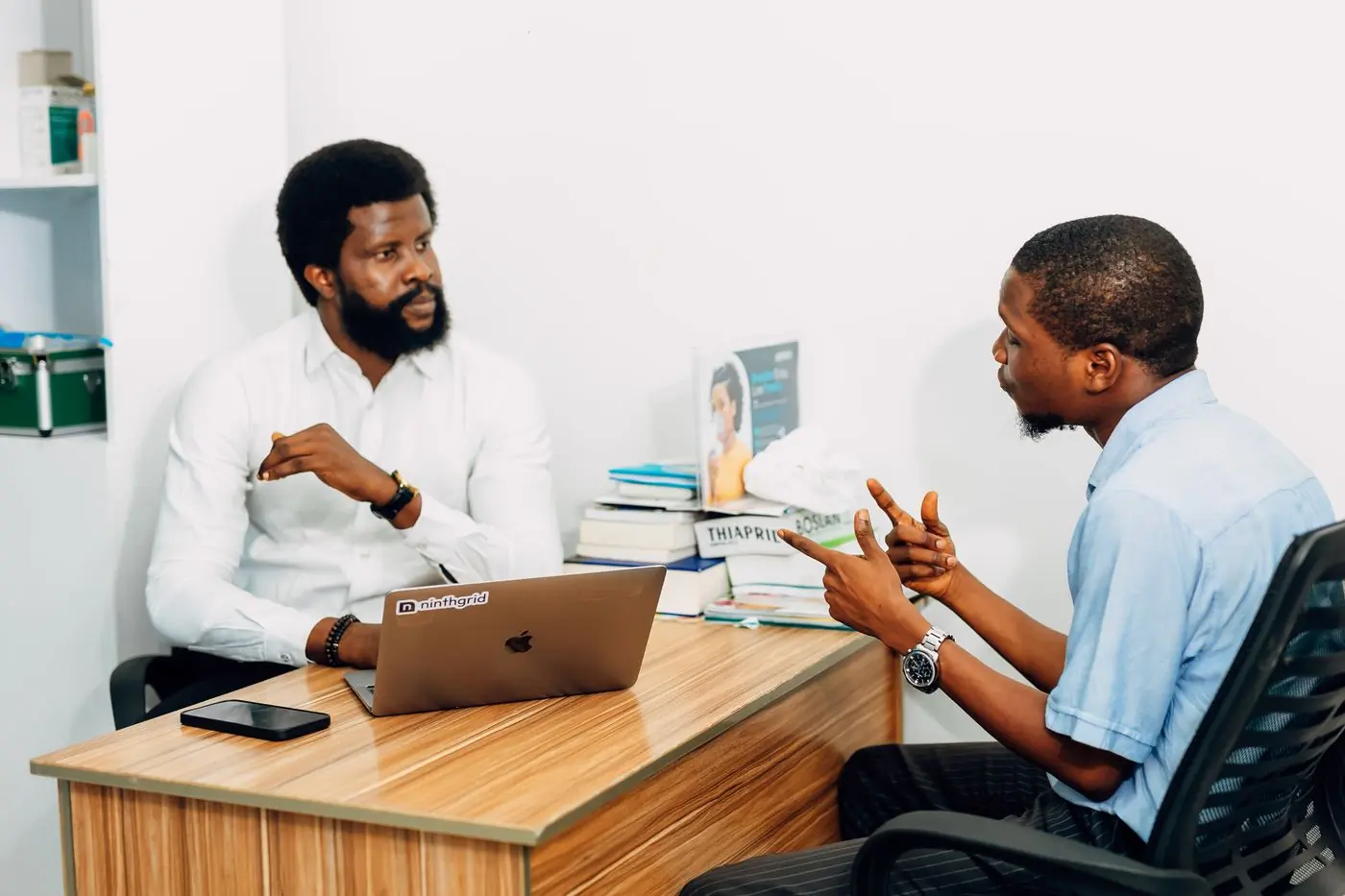 Two colleagues talking through a case in the practice office