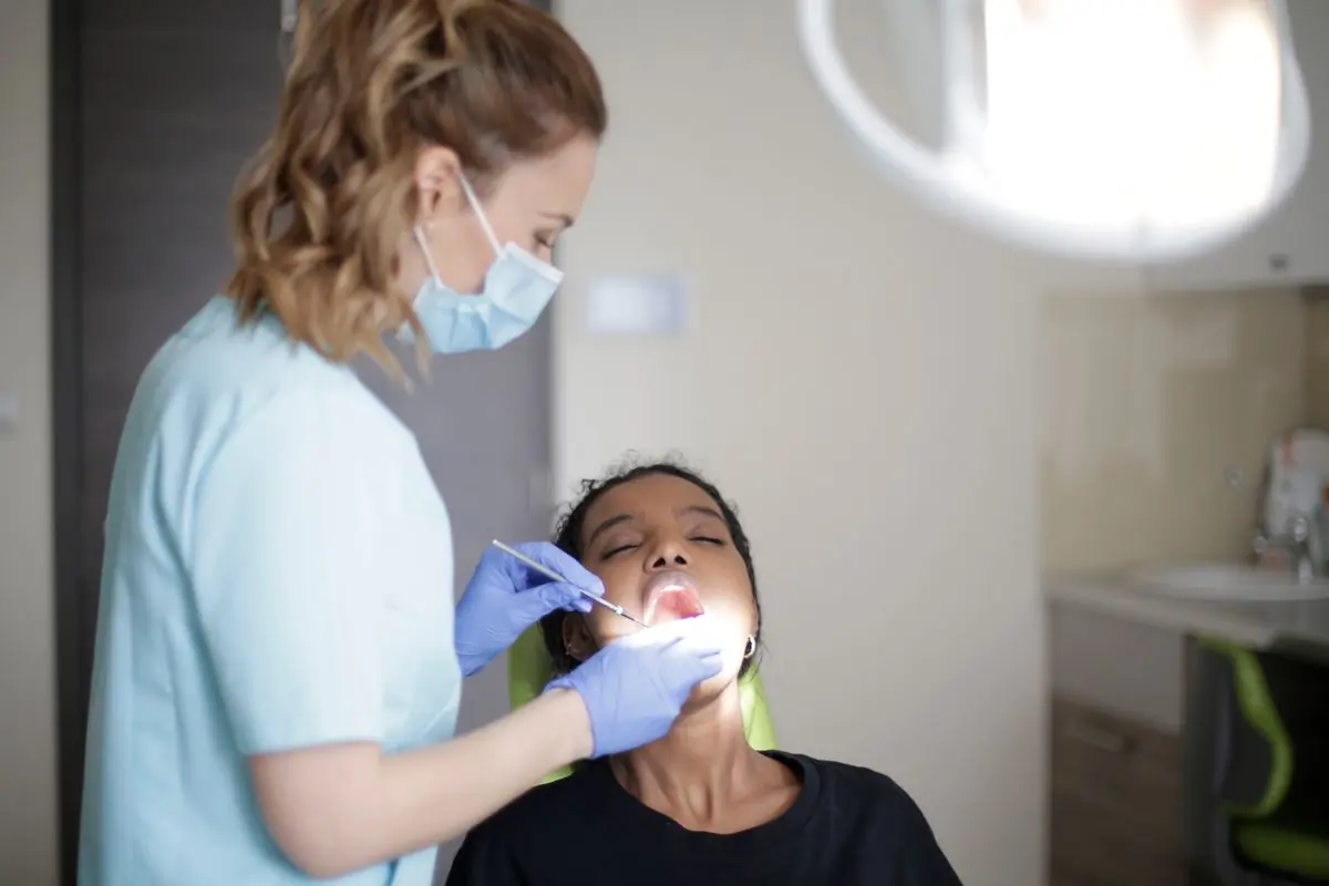 A clinician examining a patient during a routine check-up