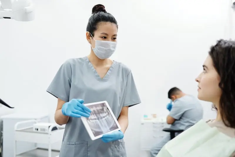 Dr. Selina Owusu-Ansah showing a patient their scan