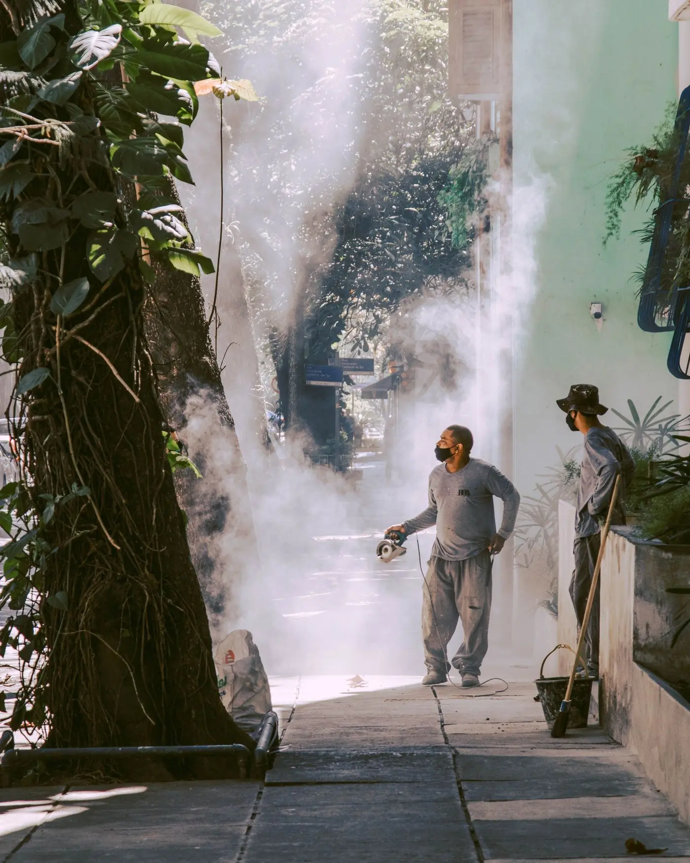 Two technicians fogging a residential street