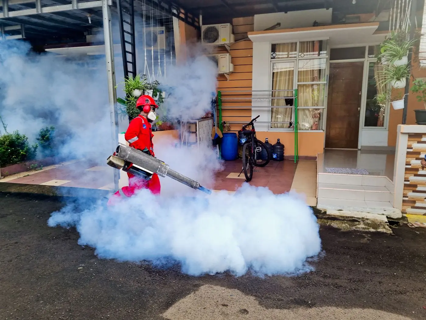 Thermal fogging outside a house at dusk
