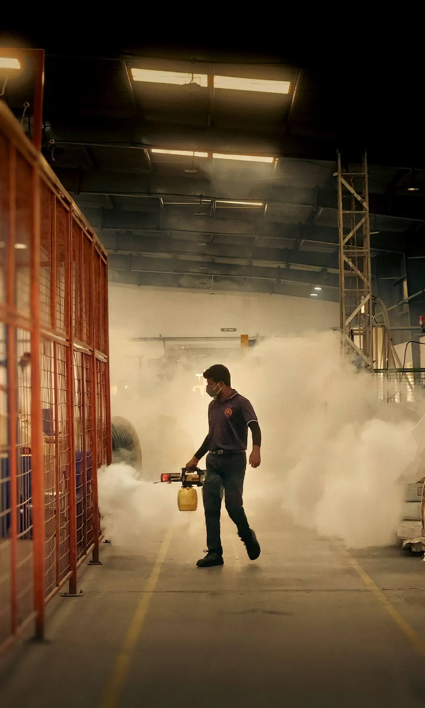 A technician treating a warehouse floor before a slab is poured