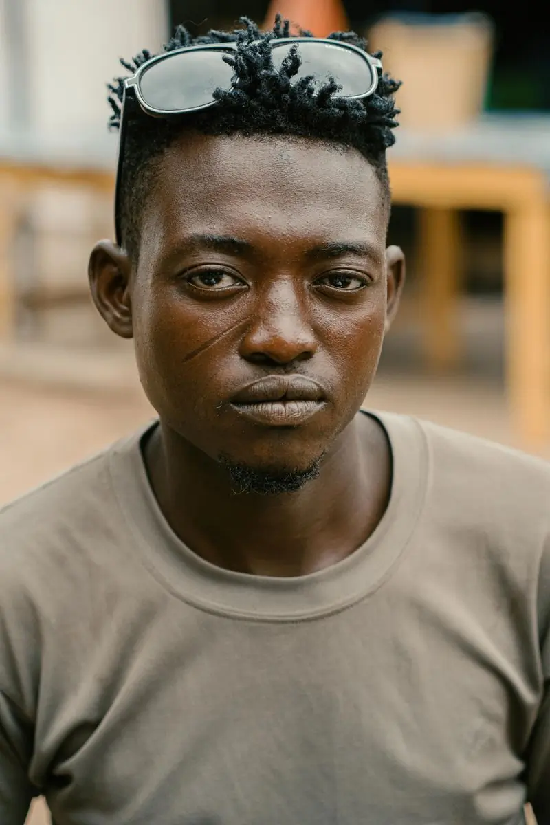 A portrait of a man photographed on the street in Kumasi
