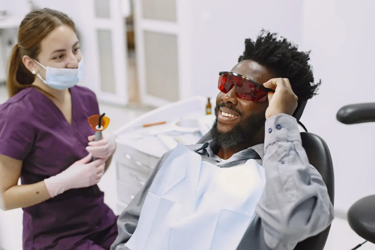 A patient smiling in the chair before treatment begins