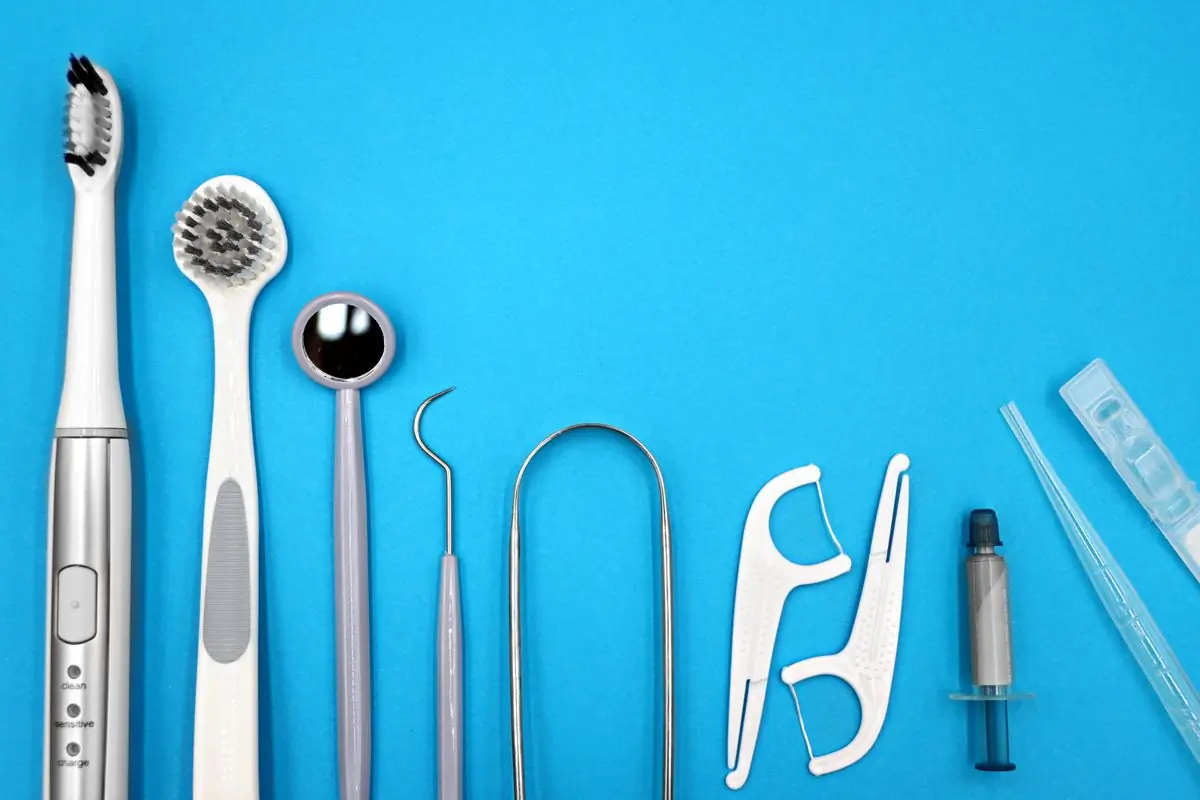 Oral care instruments laid out on a blue ground