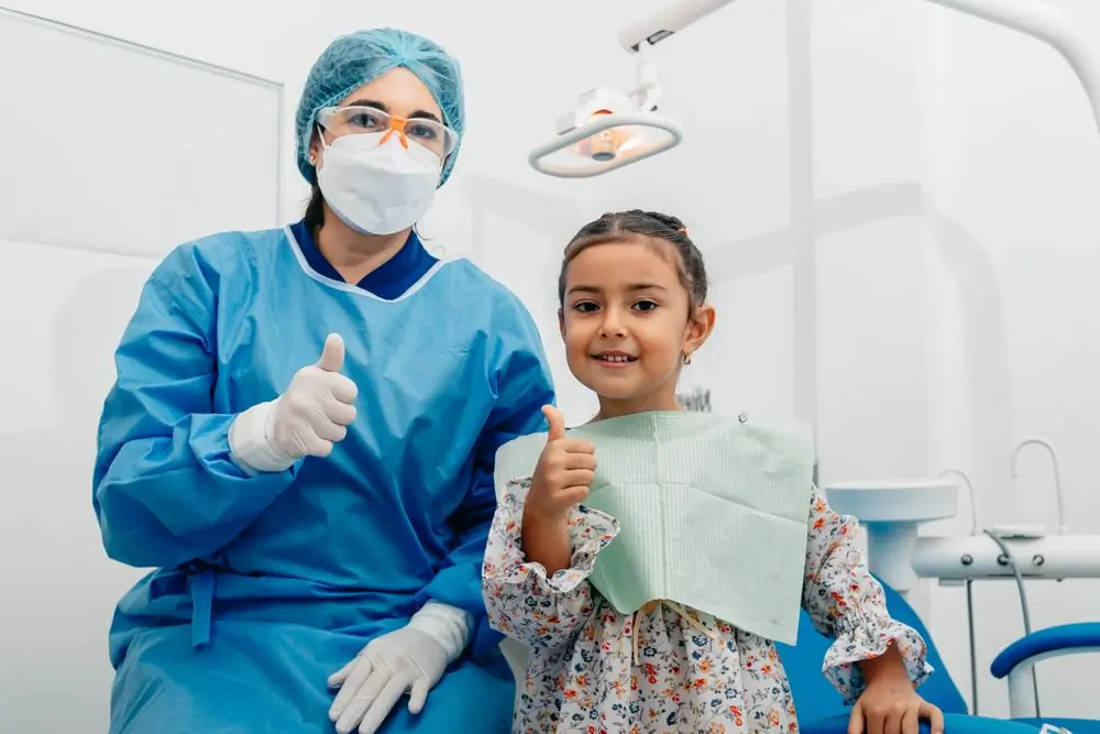 A child and her dentist after a check-up at the practice
