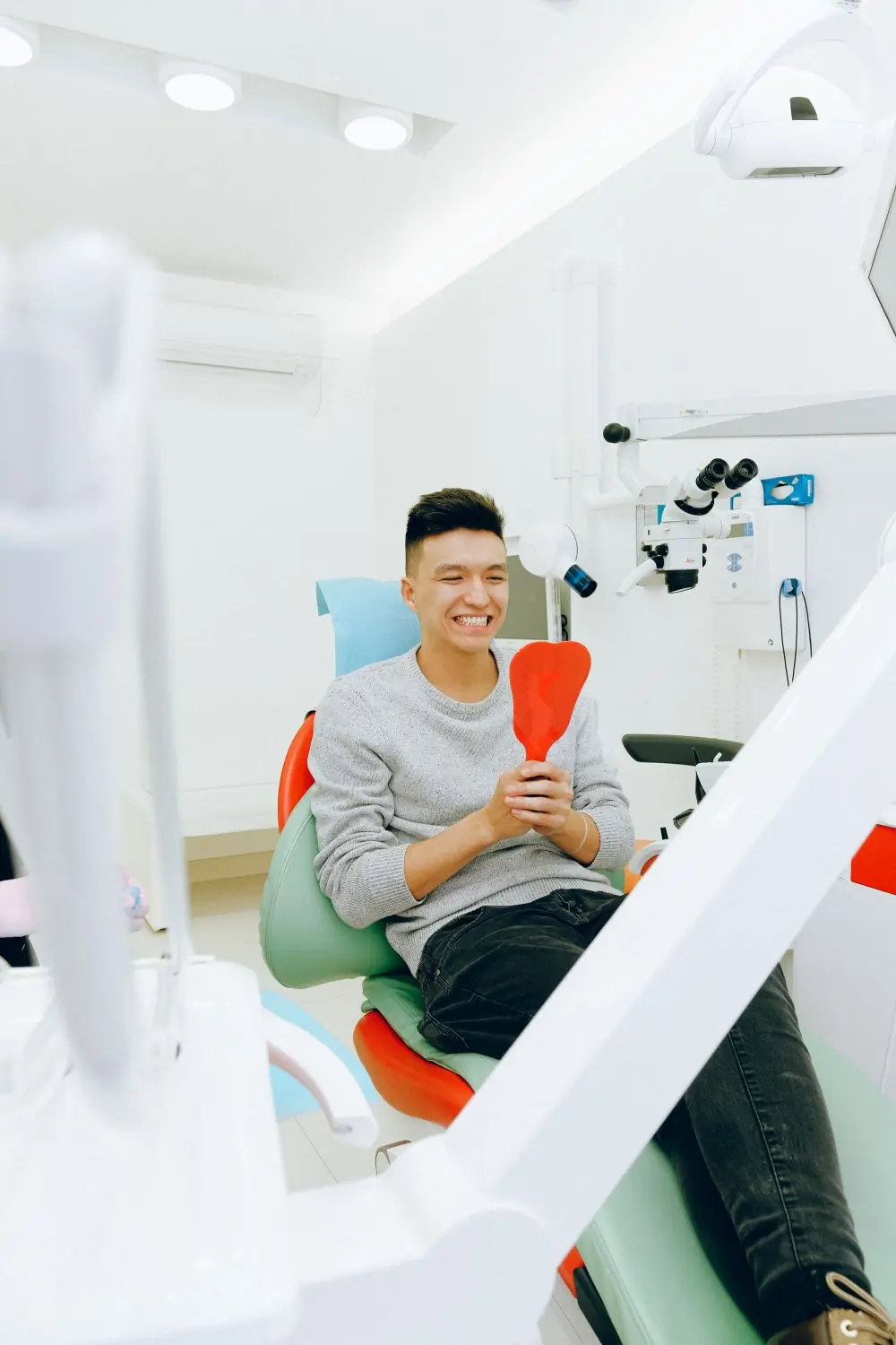 A young patient smiling after treatment at the practice