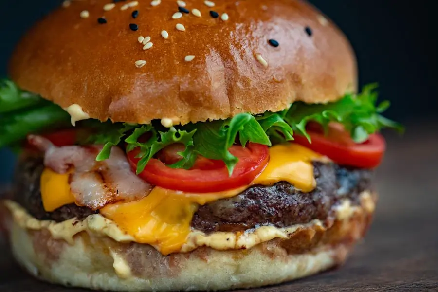 A burger with bacon, lettuce and tomato