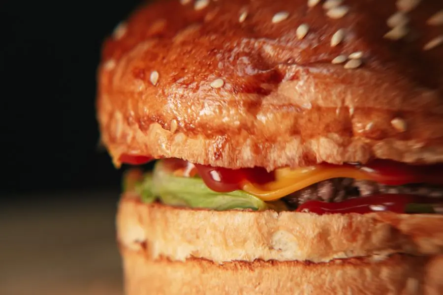An extreme close-up of a stacked cheeseburger