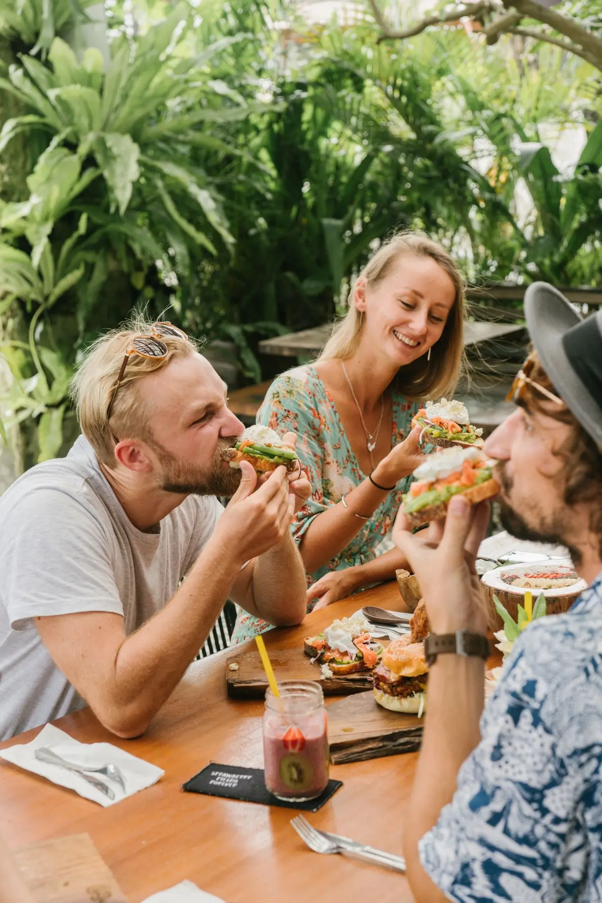 A long table of friends eating together