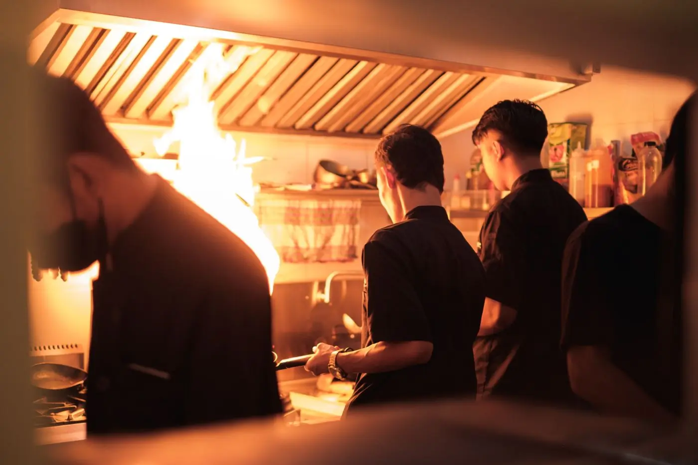 Cooks working the line in a busy restaurant kitchen