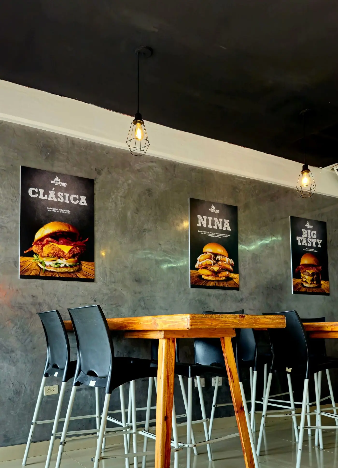 The dining room wall, hung with menu posters