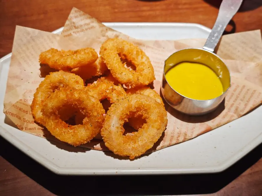 Crispy onion rings served with a mustard dip