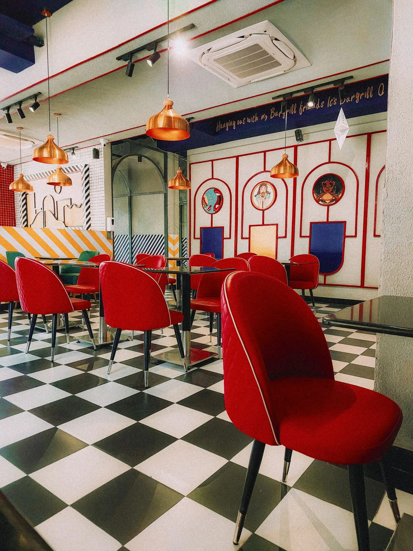 An empty parlour with red velvet chairs and a chequerboard floor at the end of service
