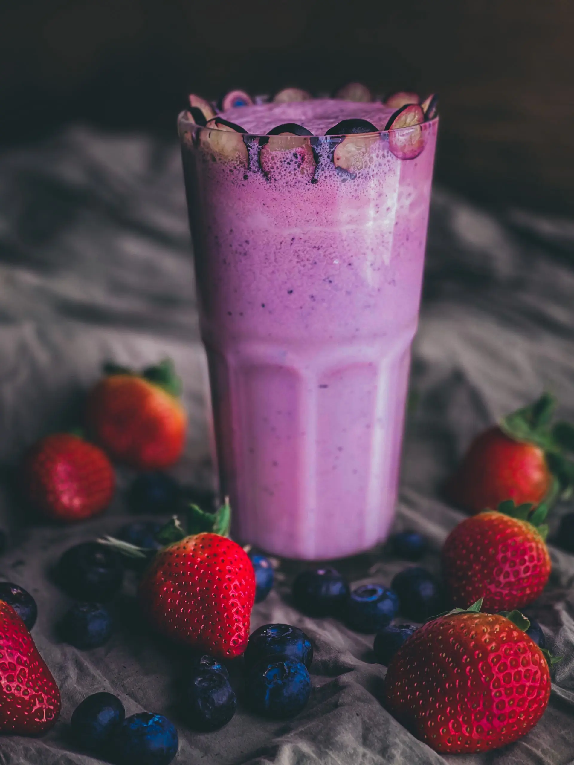A deep purple blended drink topped with berries