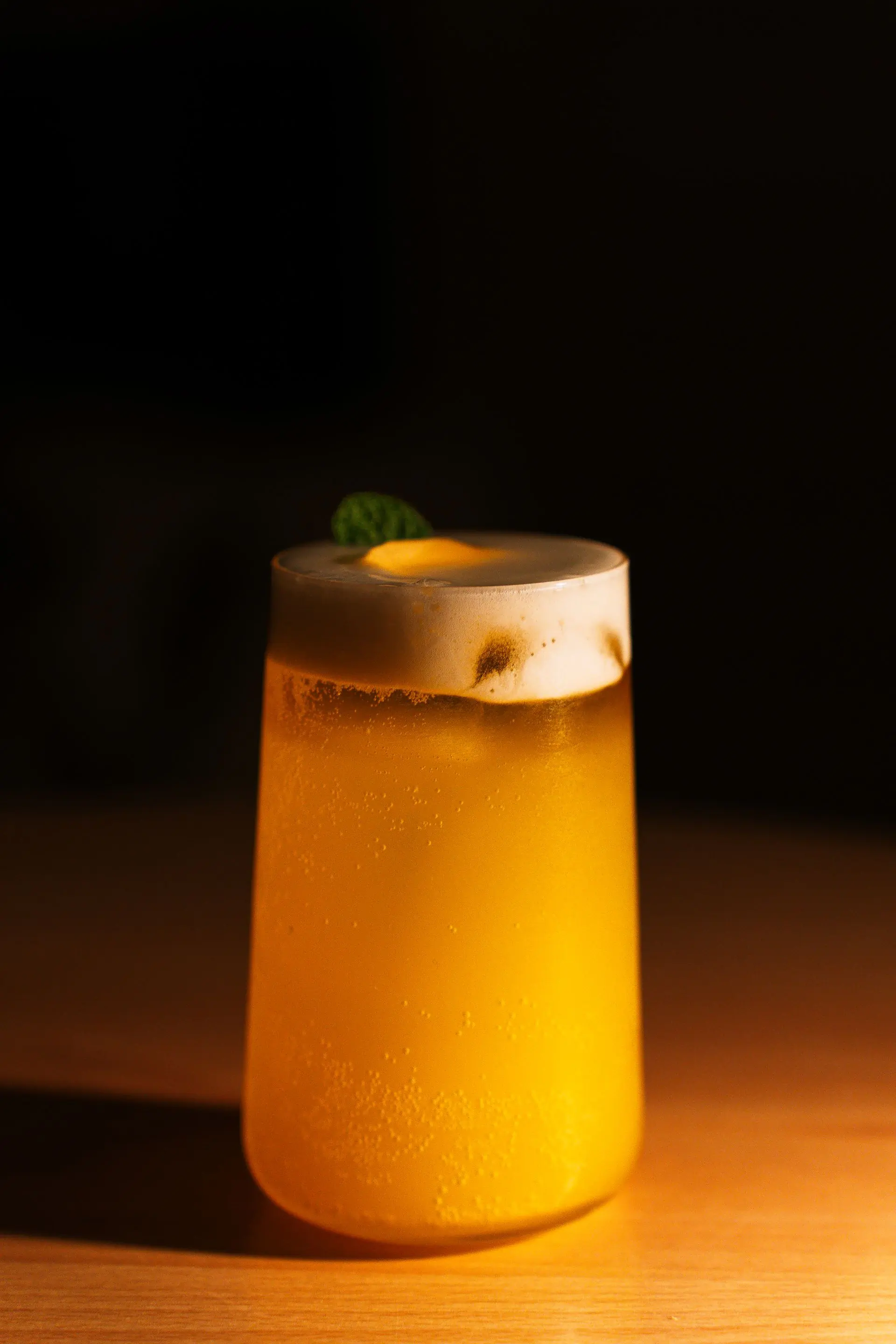 An orange citrus spritz in a stemmed glass