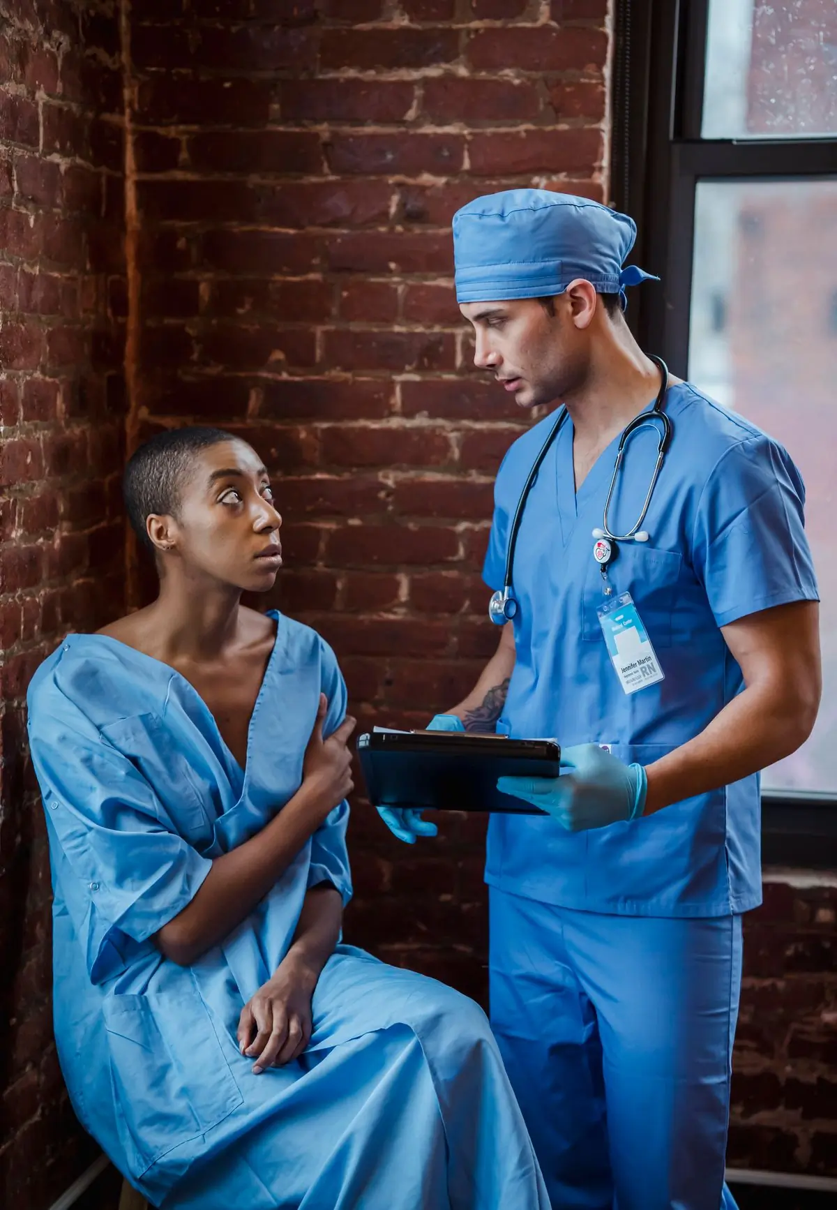 A doctor talking a patient through a diagnosis in a clinic hallway