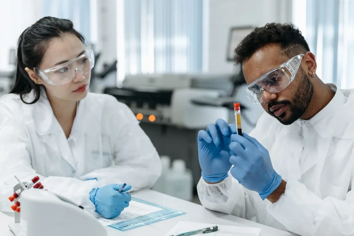 Two laboratory scientists examining a blood sample