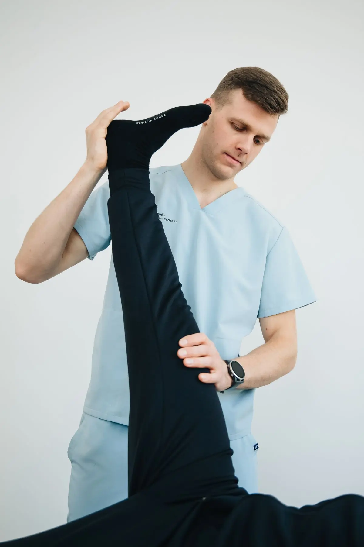 A physiotherapist working through a leg exercise with a patient