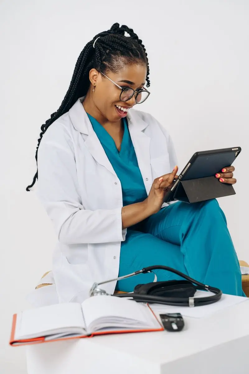 Dr. Efua Sarpong, paediatrician, holding a tablet
