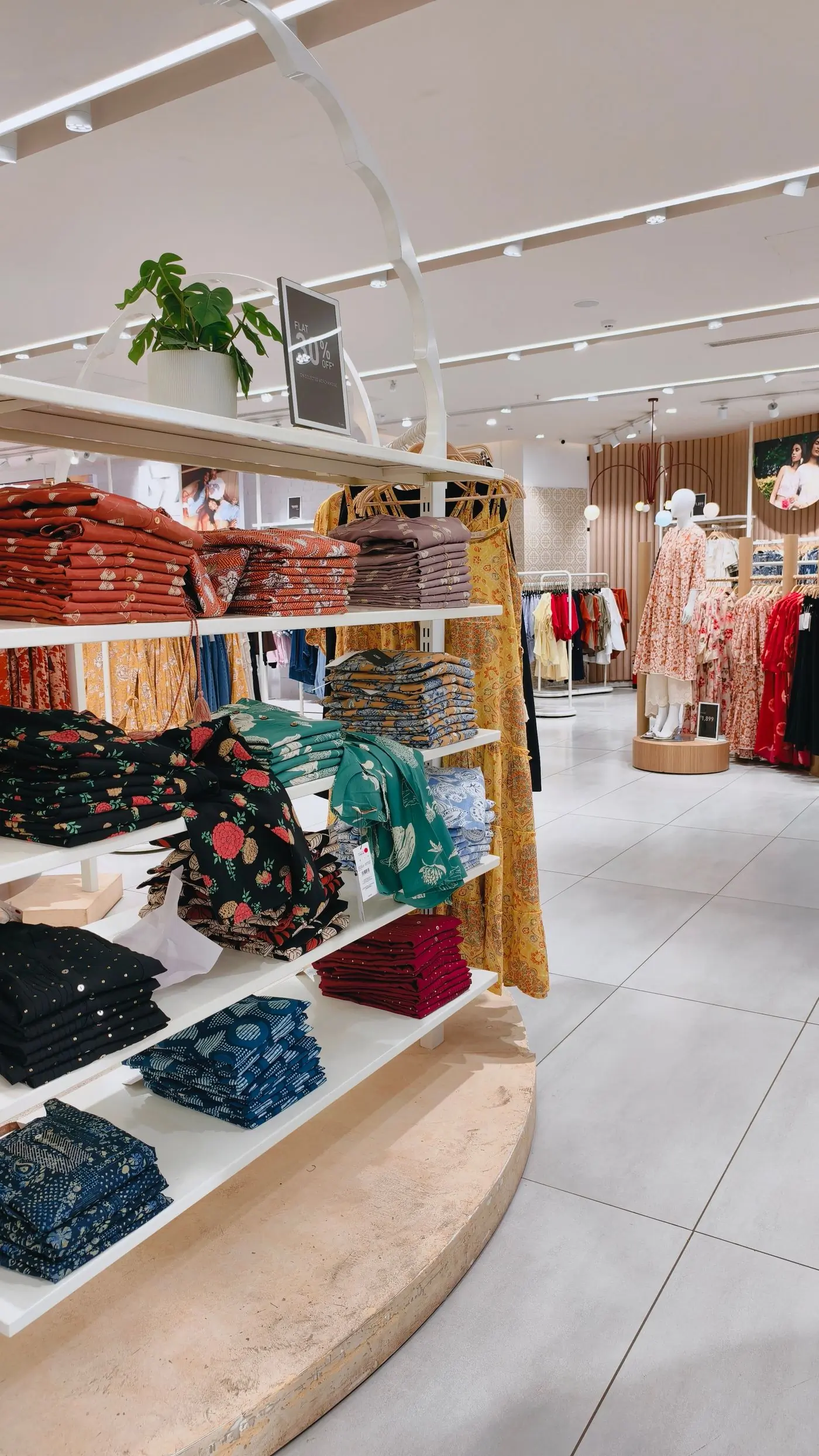 Shelves of folded printed cotton in a bright shop