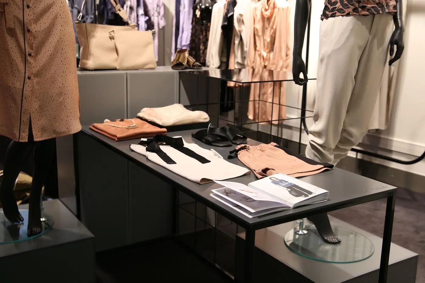 A tailored display of bags and folded pieces on a shop table