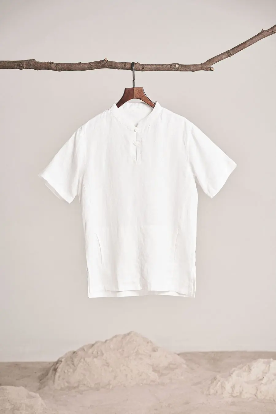 A white linen shirt on a wooden hanger