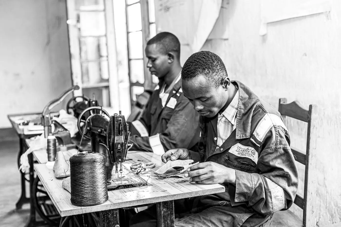 Two machinists working at their benches in a workshop