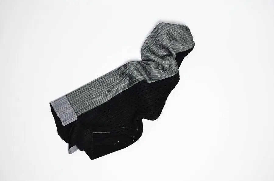 A charcoal hooded sweatshirt folded against white