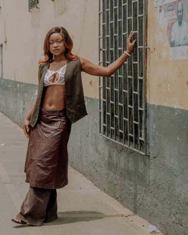 A customer in a linen waistcoat against a painted wall