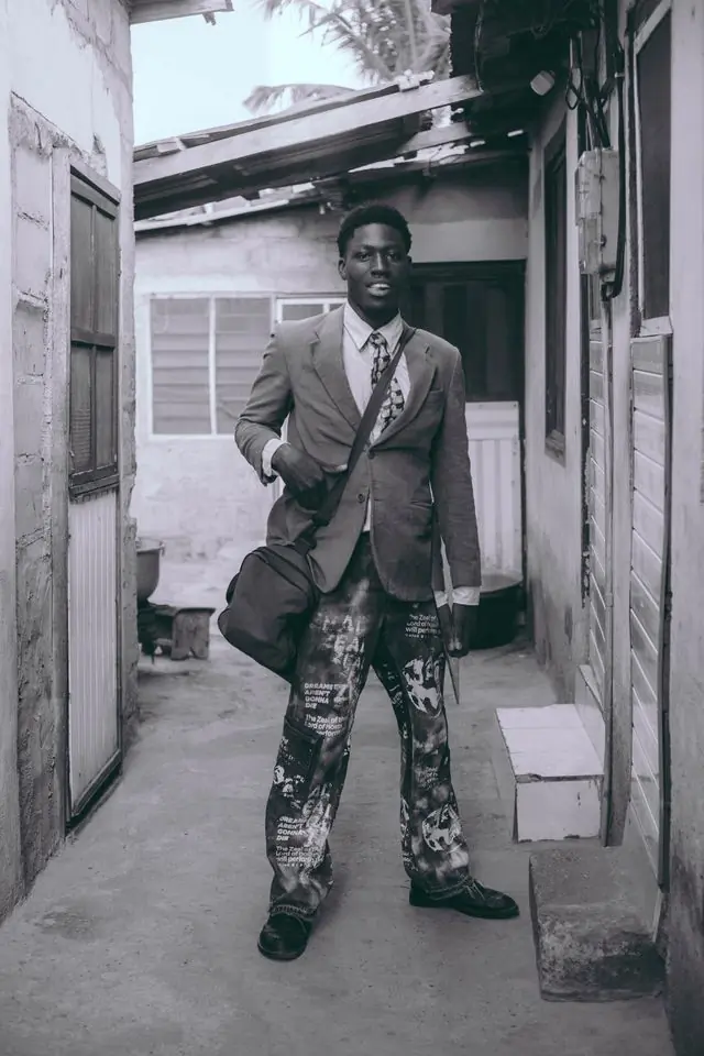 A man in a tailored jacket photographed in black and white