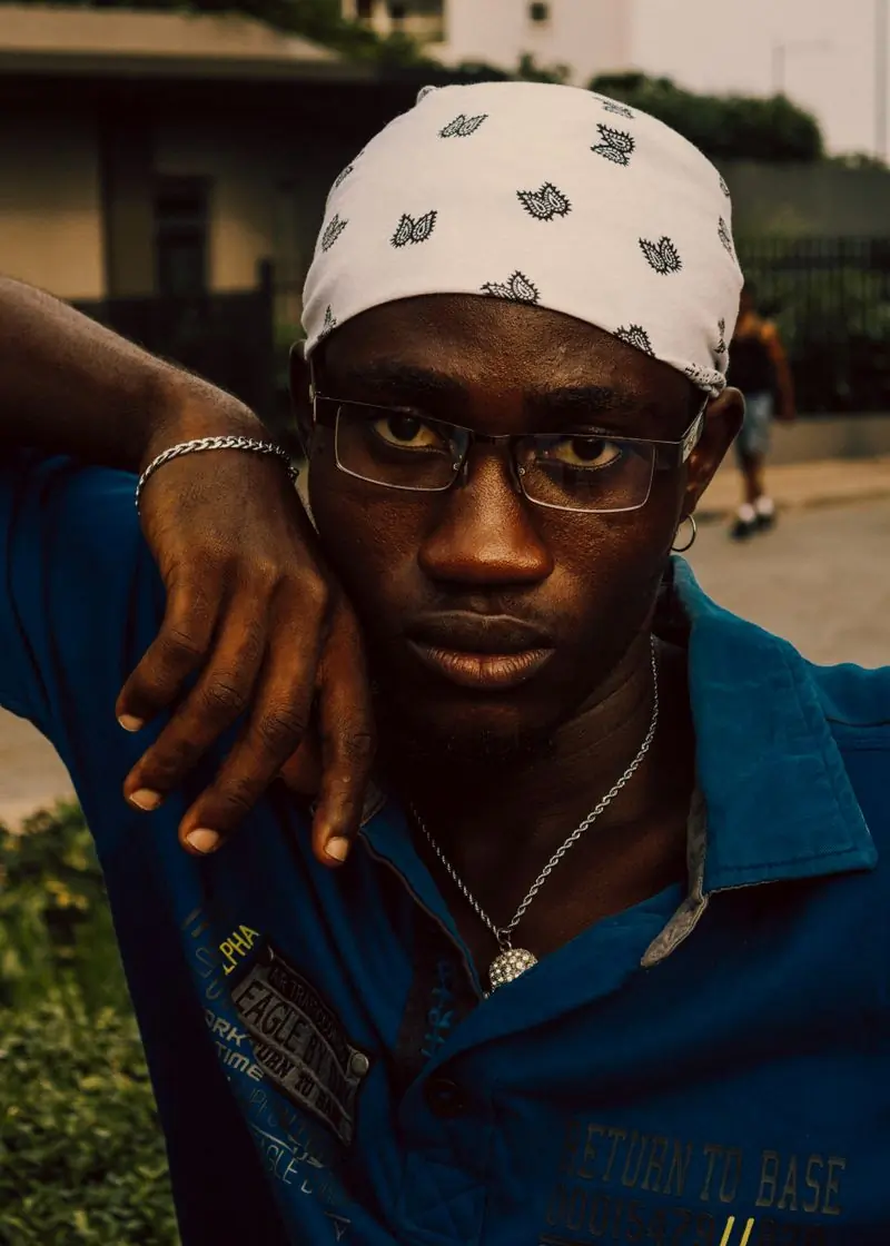 A customer in a blue corduroy shirt and glasses