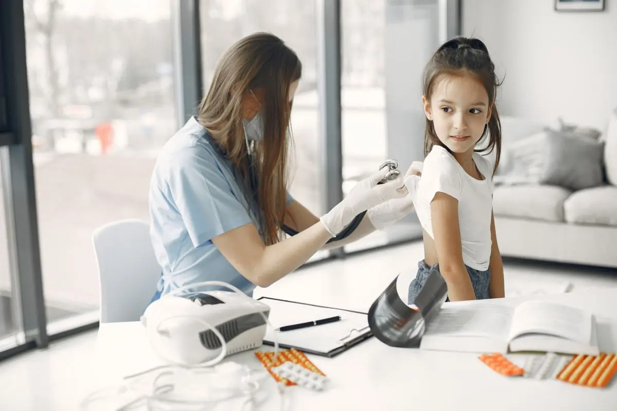 A doctor examining a young girl during a checkup