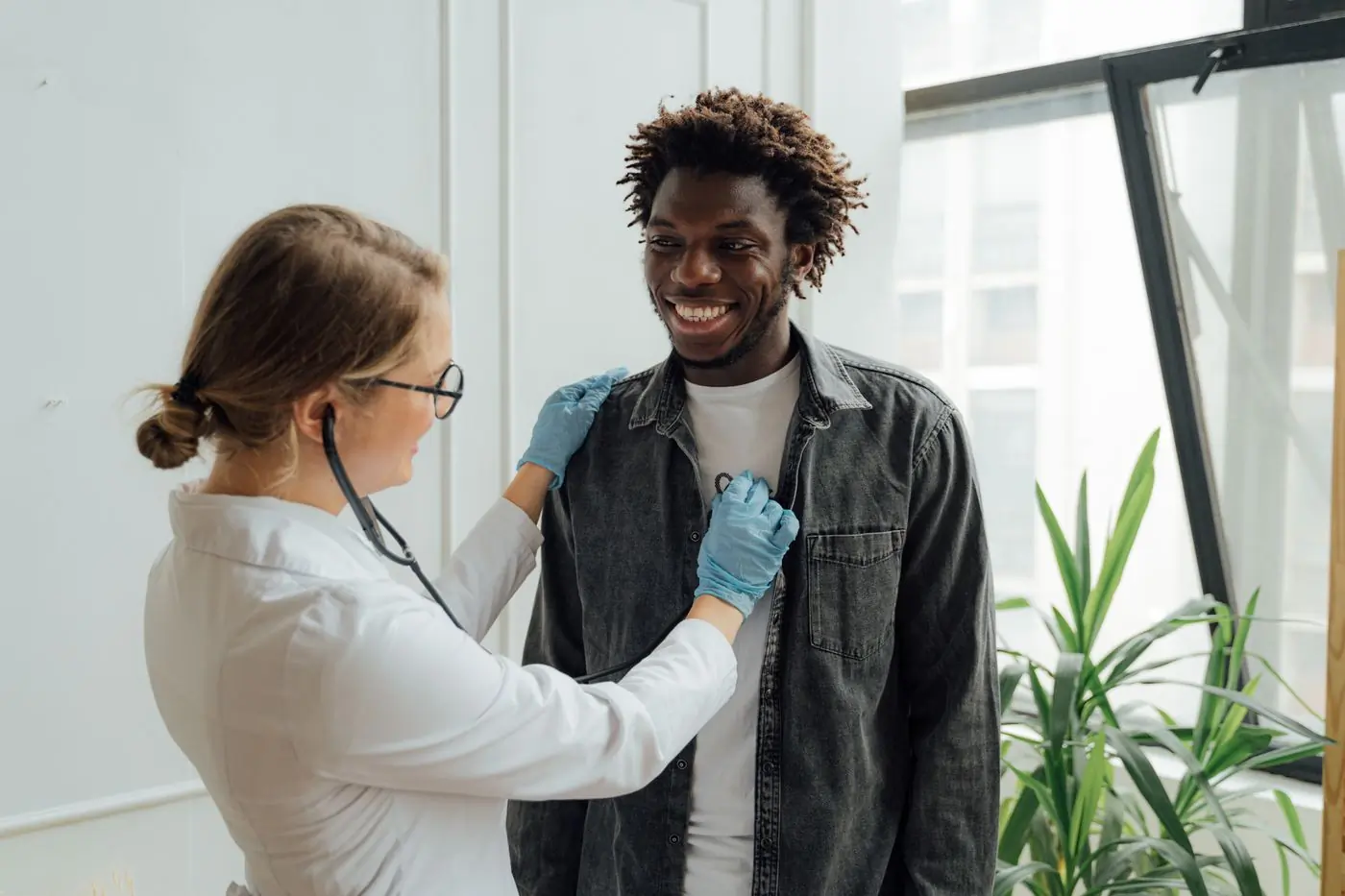 A doctor listening to a patient's chest with a stethoscope