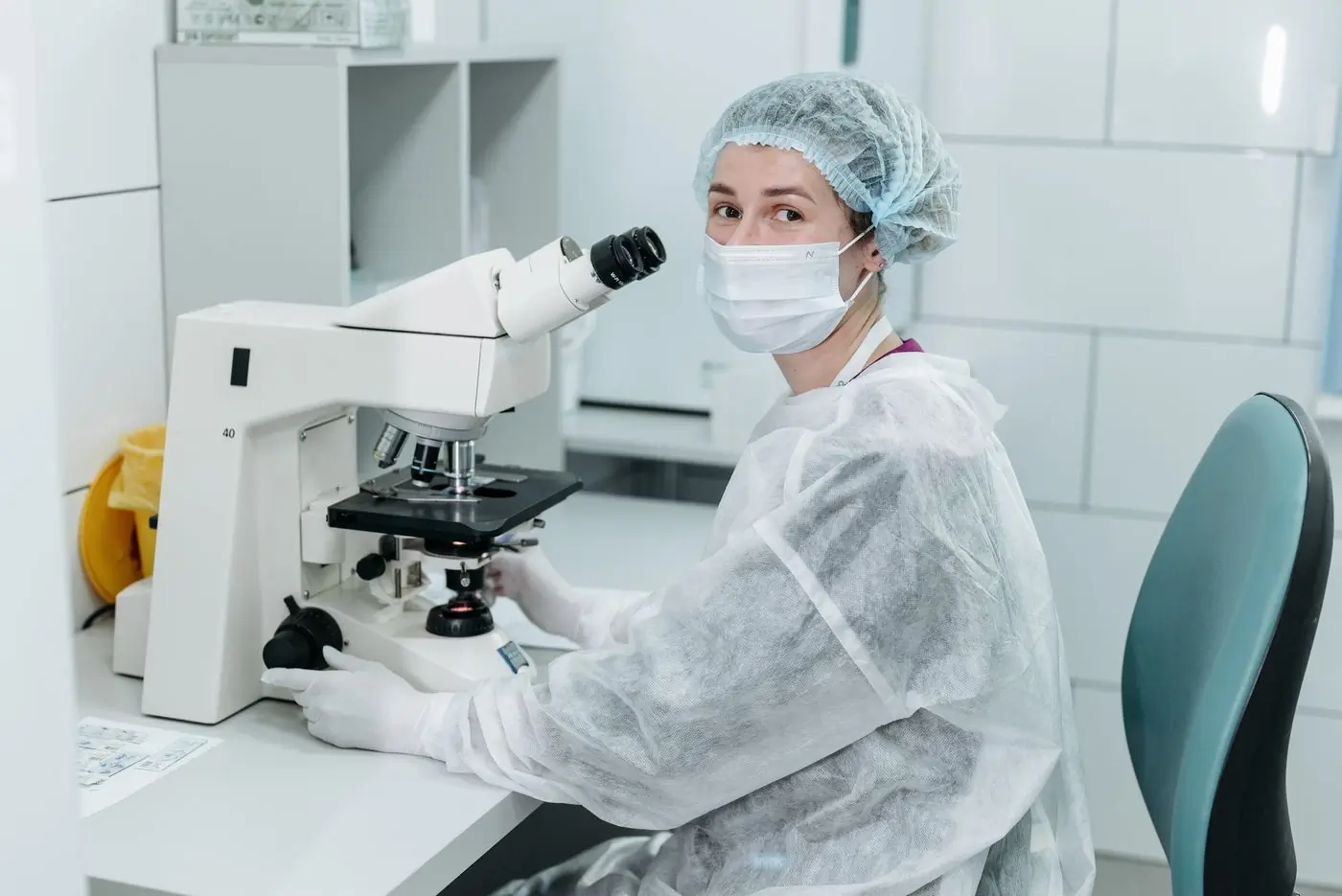 A laboratory scientist working at a microscope