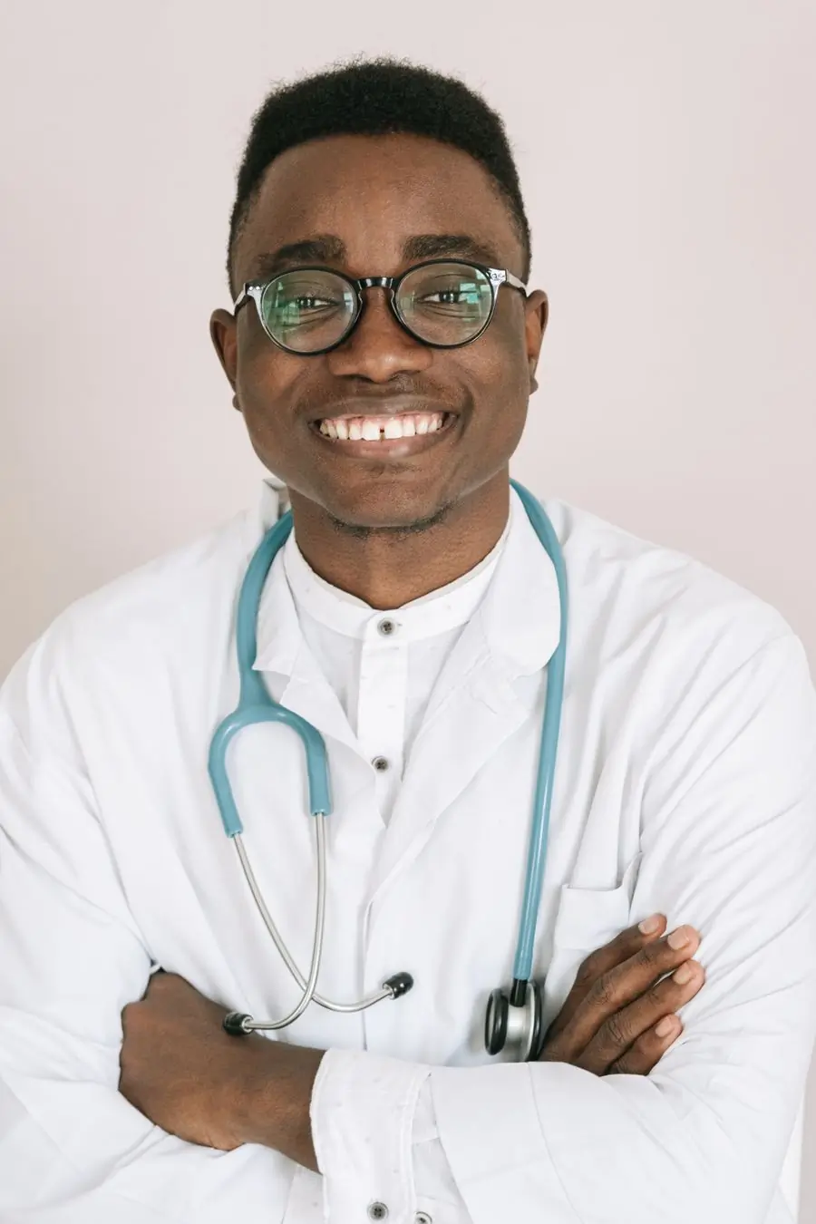 Dr. Kwabena Asare, consultant cardiologist, in a white coat and stethoscope
