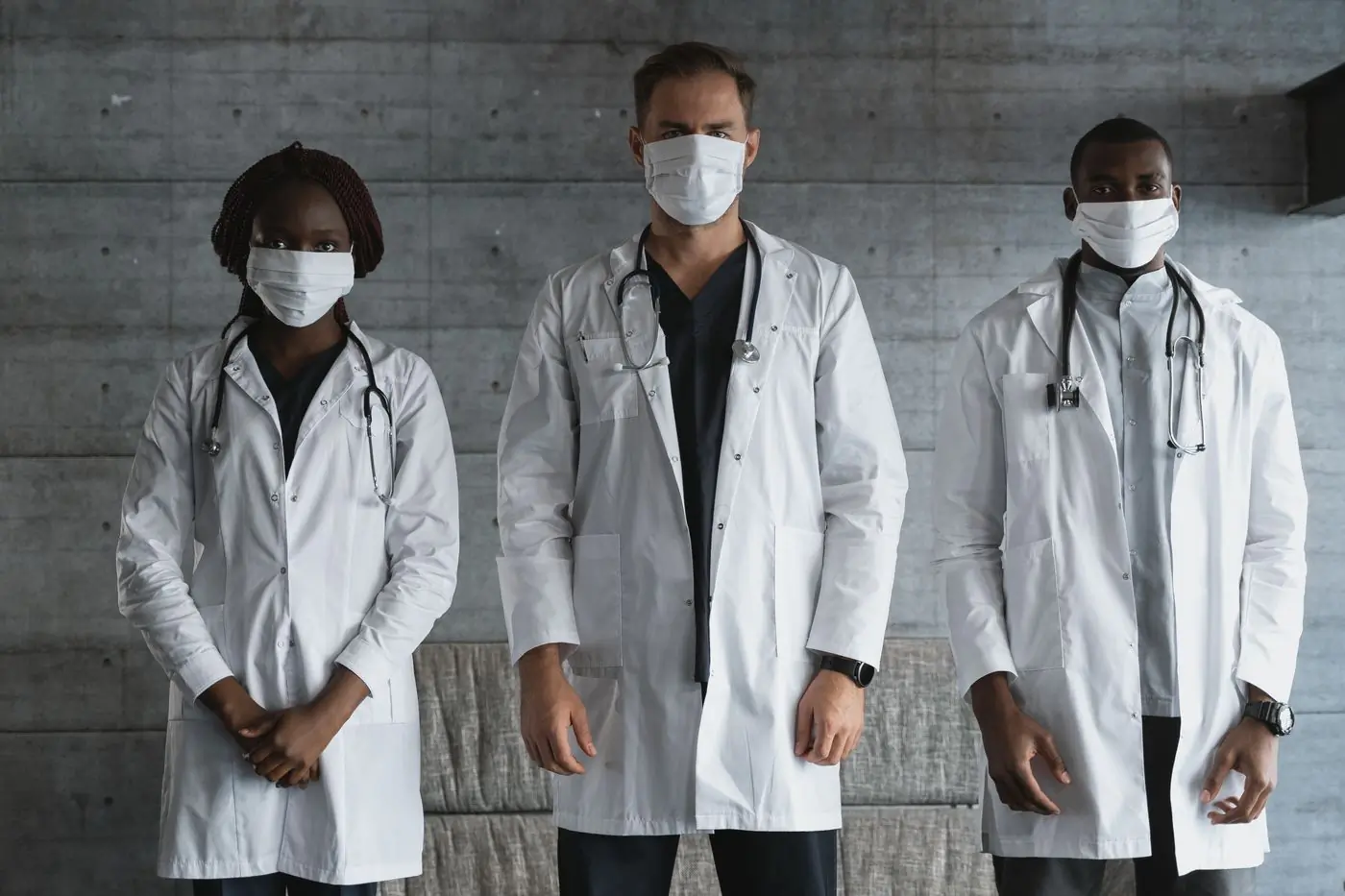Clinic staff in coats and masks at the start of a shift