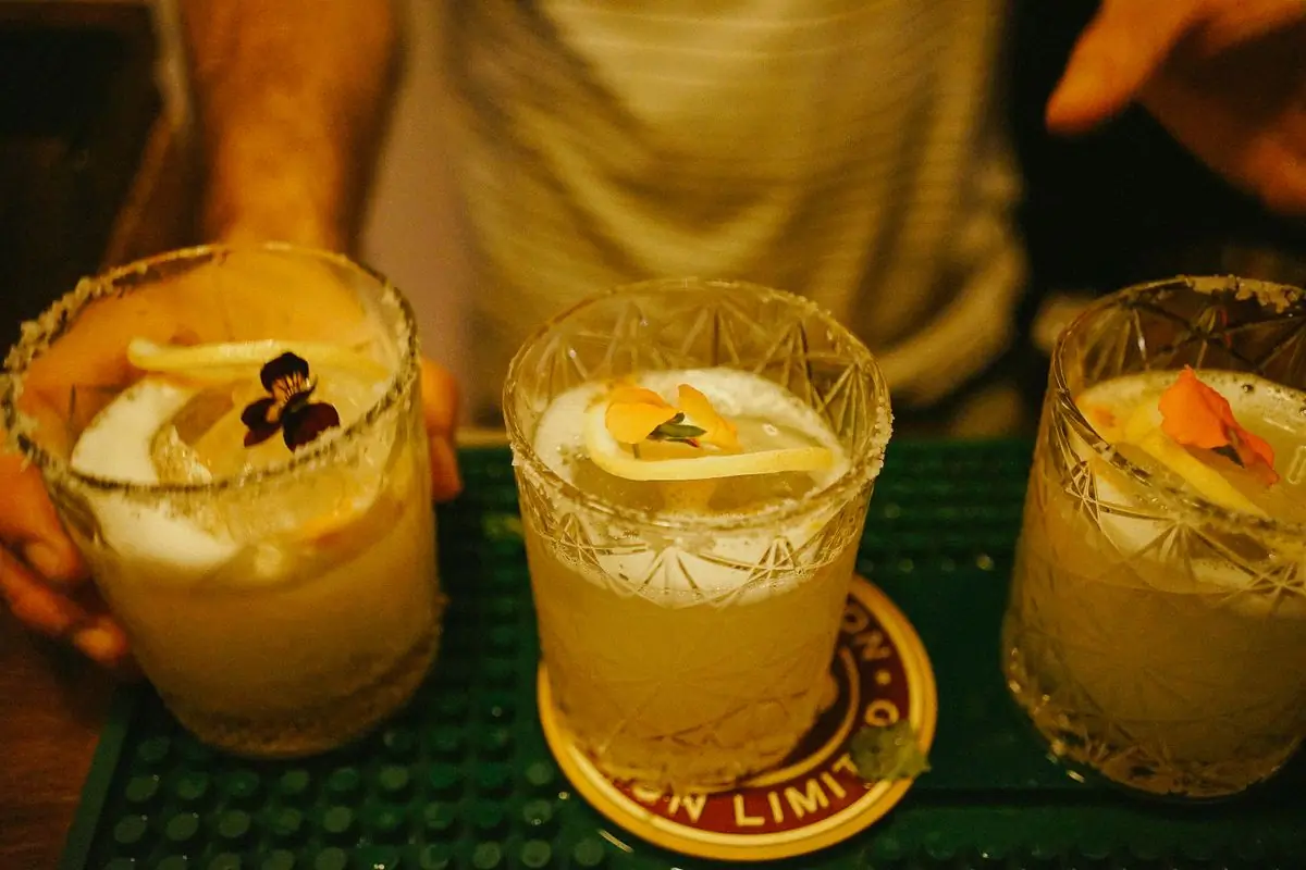 Cocktails poured at the bar with lime