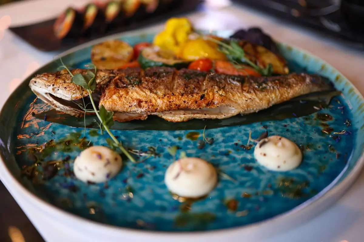 Grilled red snapper plated with green pepper shito