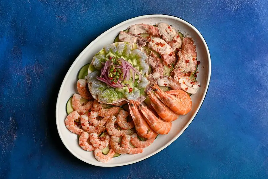 Prawns fanned around a bowl of green sauce