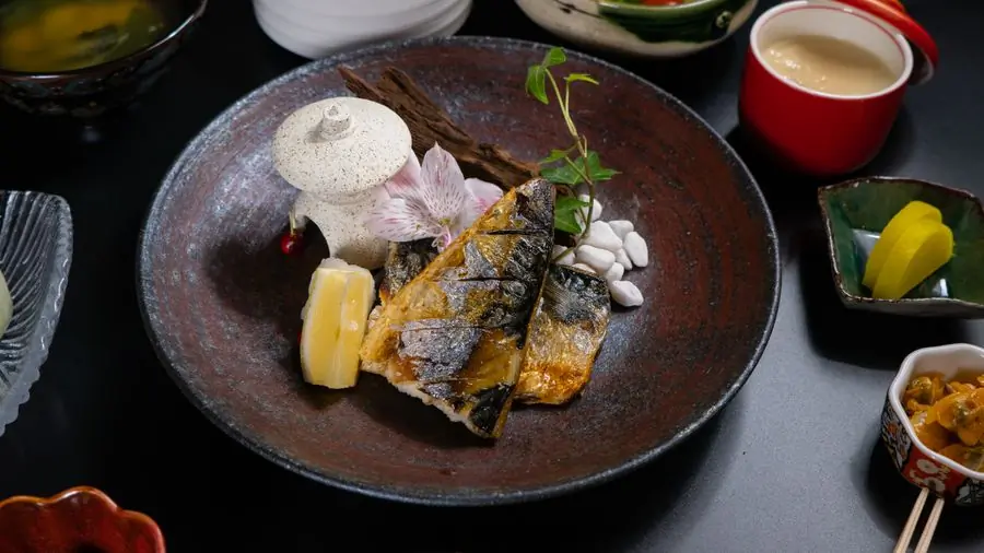 A fillet plated dark with herbs and citrus
