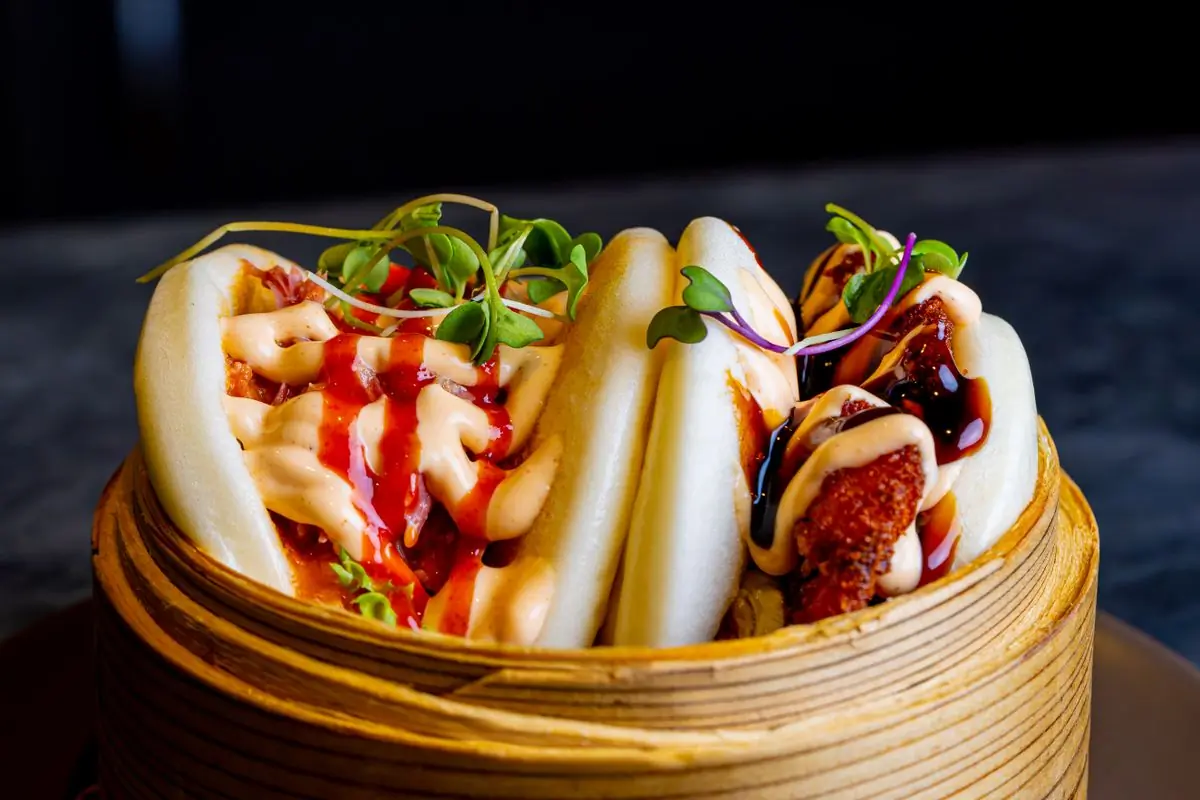 Bao buns filled with pork and fresh herbs