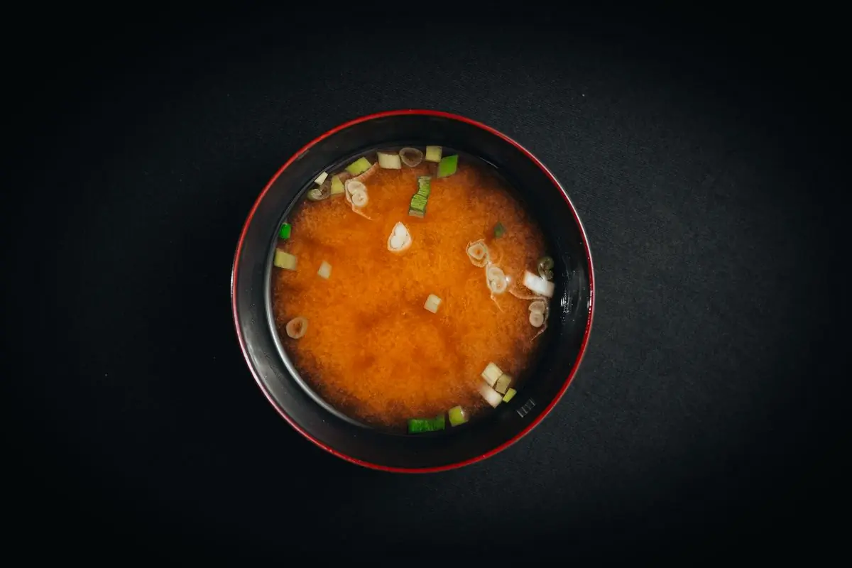 A black bowl of miso soup