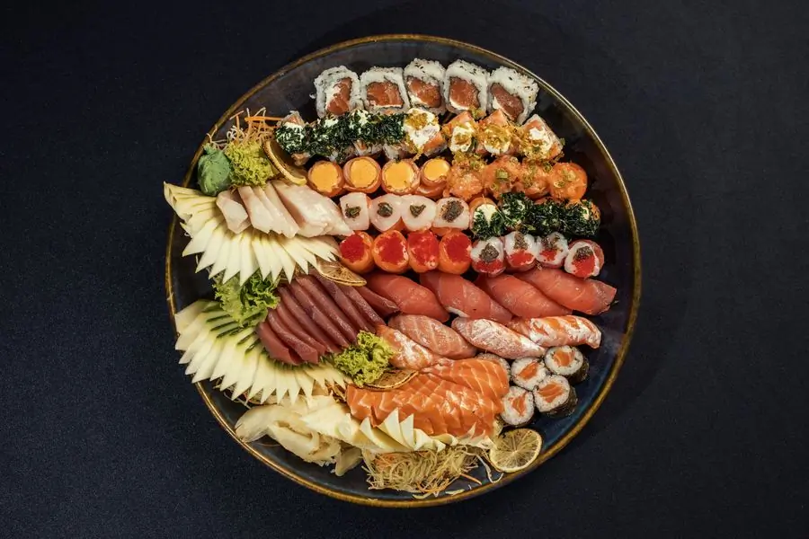 An assorted sushi platter on a dark ground, seen from above