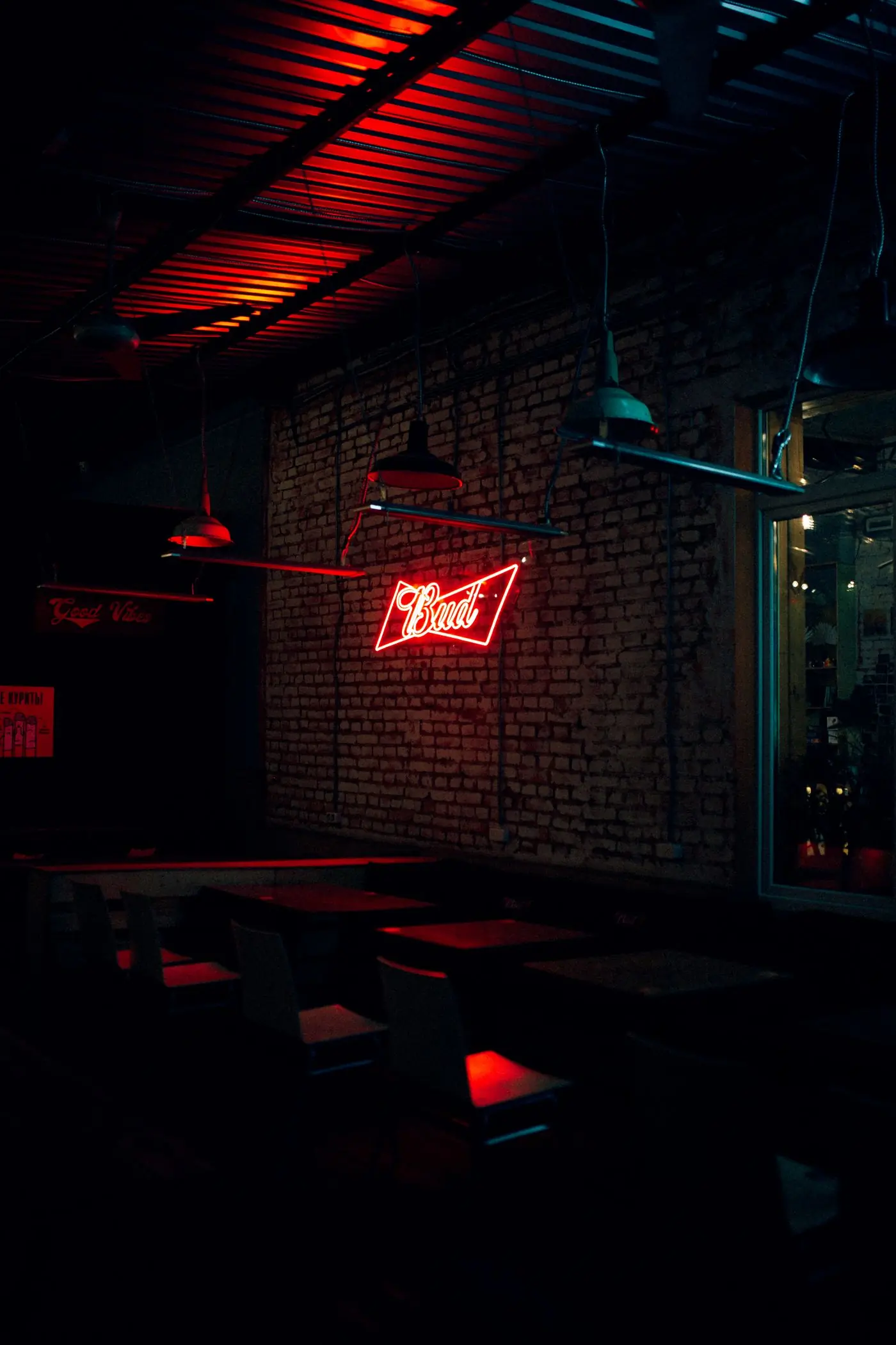 A neon sign glowing on a dark brick wall
