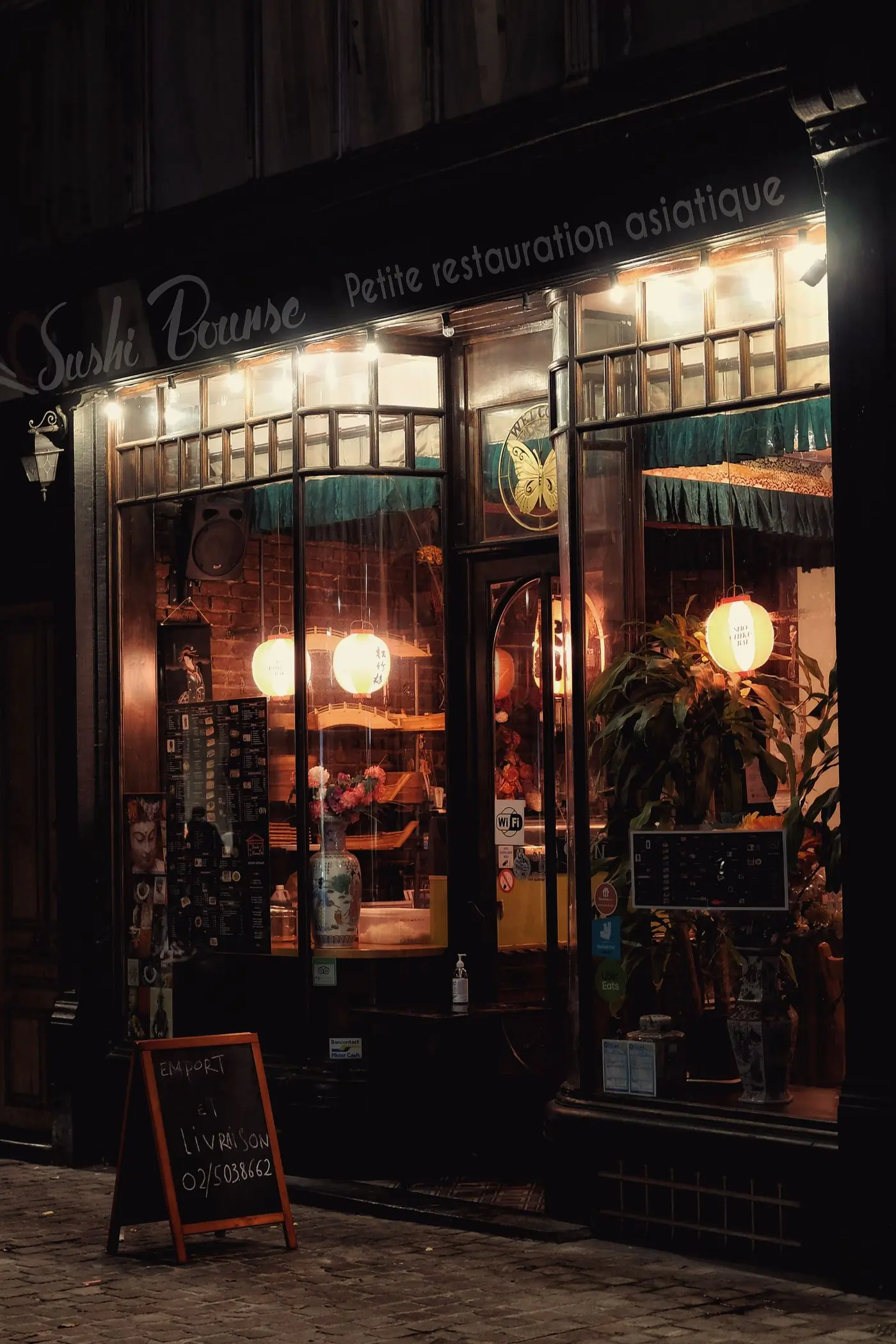 The front of the restaurant at night from Lagos Avenue