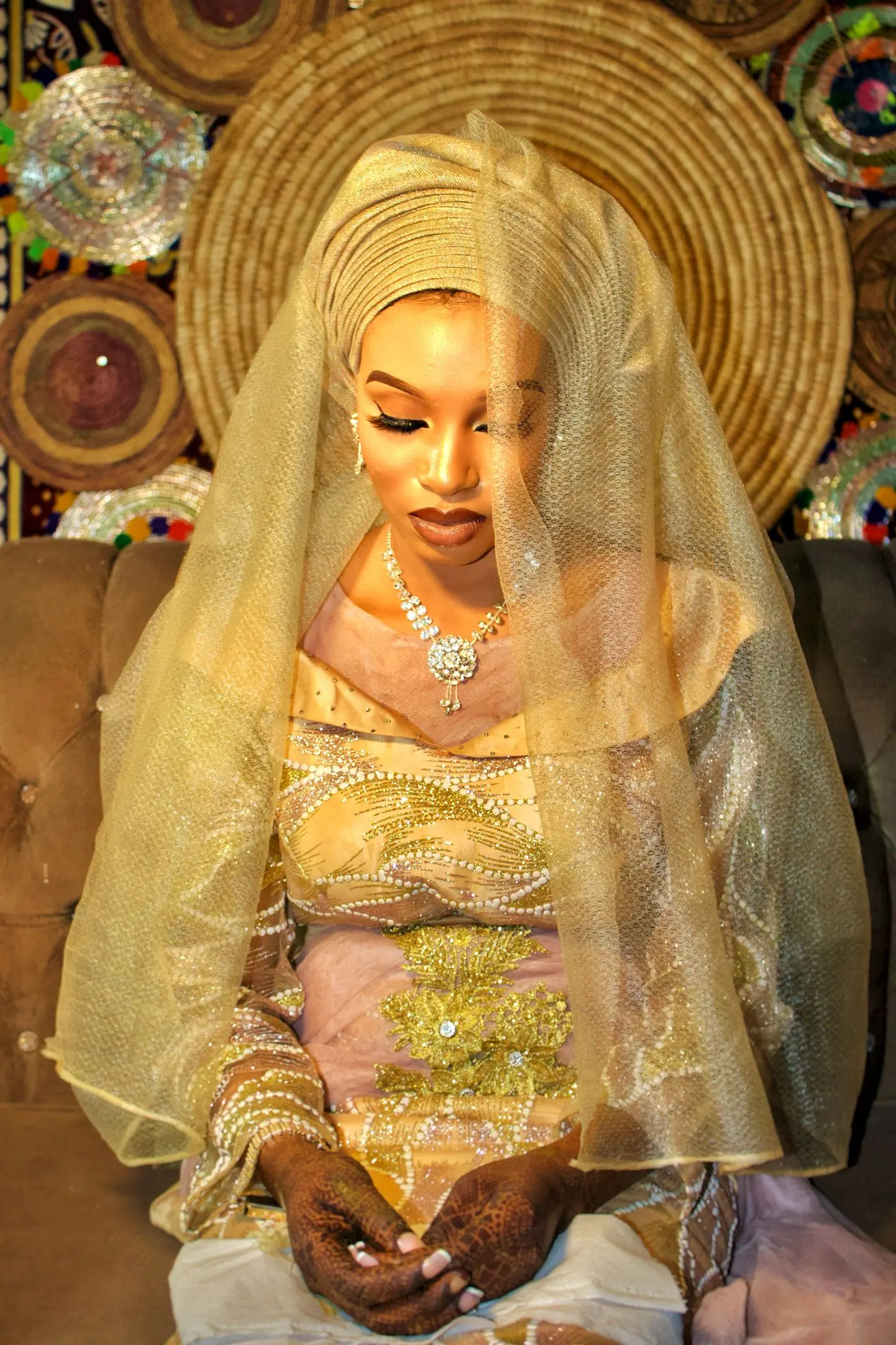 A bride in a gold embroidered veil at her traditional engagement