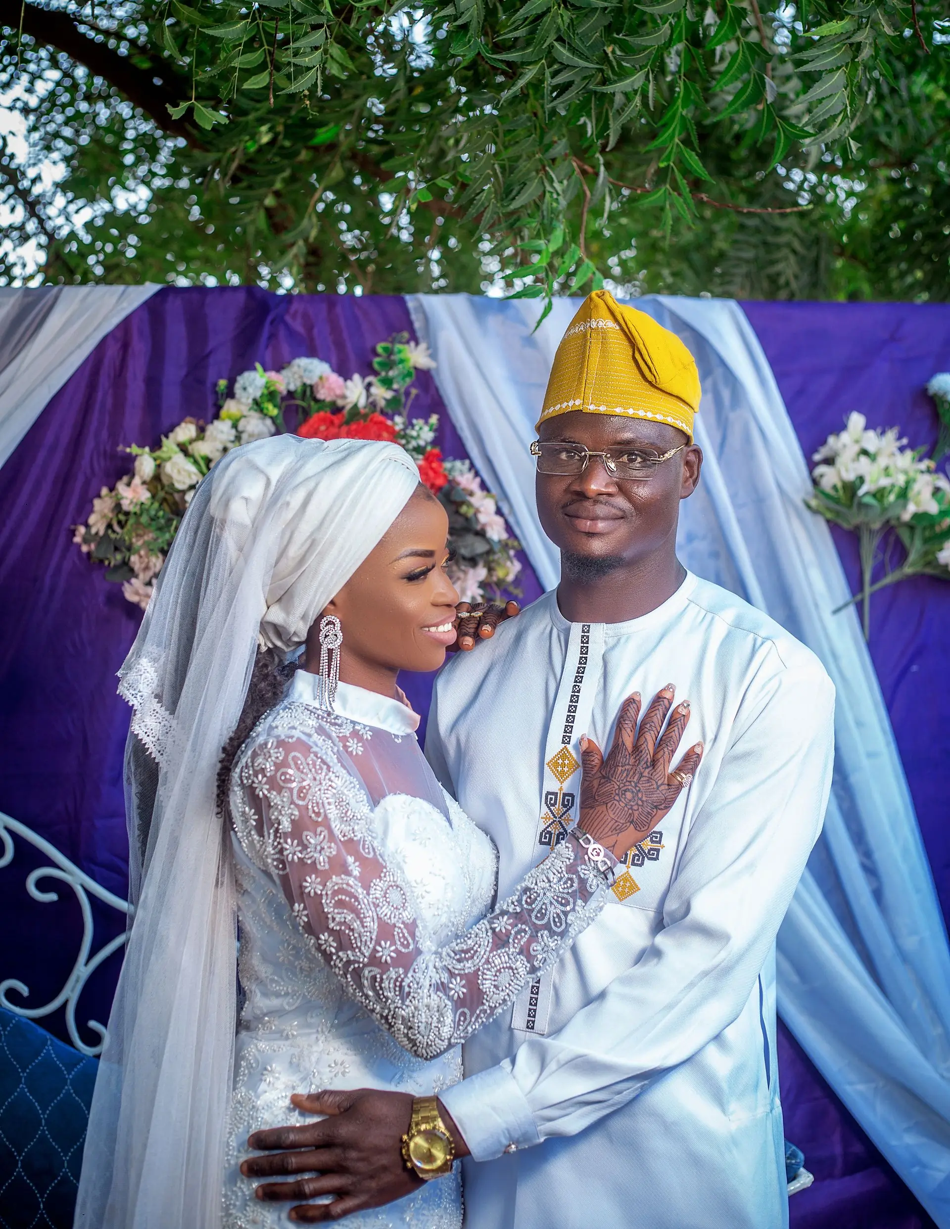 A couple in traditional Nigerian wedding dress standing together at their engagement