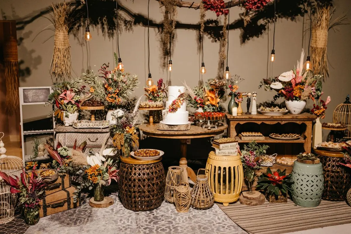 A reception laid with lanterns, dried grasses and warm low light