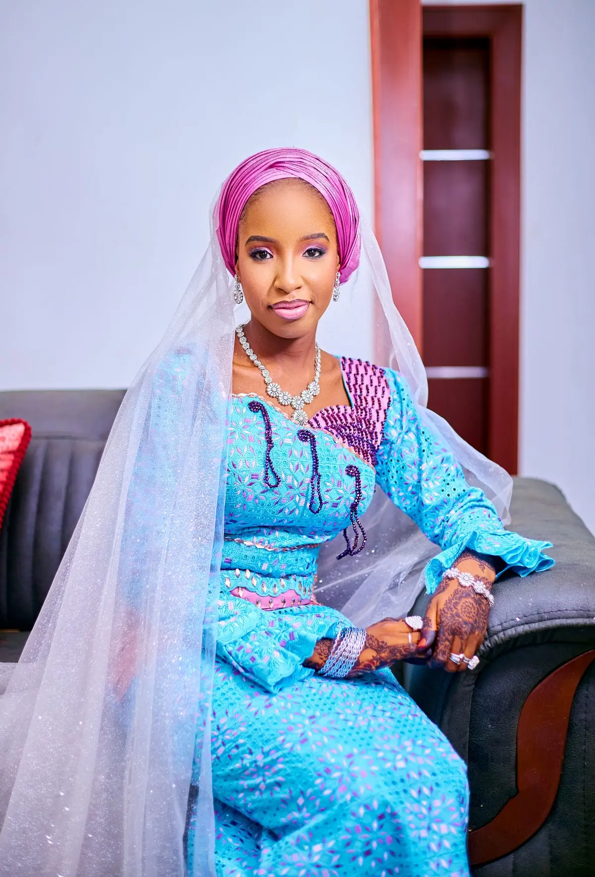 A bride seated in blue and white traditional dress at her engagement